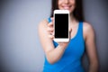 Woman showing blank smartphone screen. Focus on smartphone Royalty Free Stock Photo