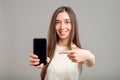 Woman showing blank smartphone screen Royalty Free Stock Photo