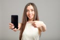 Woman showing blank smartphone screen Royalty Free Stock Photo