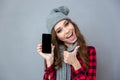 Woman showing blank smartphone screen and thumb up Royalty Free Stock Photo