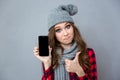 Woman showing blank smartphone screen and thumb up Royalty Free Stock Photo