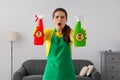 Woman showing bottles of toxic household chemical with warning signs