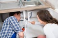 Woman Showing Damage In Sink Pipe To Plumber Royalty Free Stock Photo