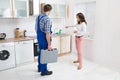 Woman Showing Damage In Sink To Plumber Royalty Free Stock Photo