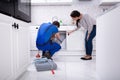 Woman Showing Damaged Sink To Plumber Royalty Free Stock Photo