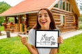 Woman showing digital tablet with house drawing Royalty Free Stock Photo