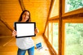 Woman showing digital tablet in the wooden house Royalty Free Stock Photo
