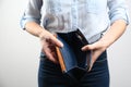 Woman showing empty wallet on light background Royalty Free Stock Photo