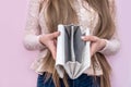 Woman showing empty wallet on pink background Royalty Free Stock Photo