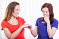 Woman showing engagement ring to her friend