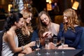 Woman showing engagement ring to her friends