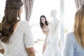 Woman Showing Her Chosen Wedding Dress To Friends