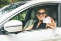 Woman showing her driver license through the car win Royalty Free Stock Photo