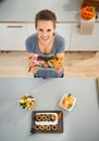 Woman showing horribly tasty treats for halloween party Royalty Free Stock Photo