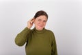 Woman showing how to insert a hearing aid Royalty Free Stock Photo