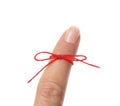 Woman showing index finger with tied red bow as reminder on white background, closeup Royalty Free Stock Photo