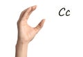 Woman showing letter C on background, closeup. Sign language