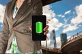 Woman showing a mobile phone with green full battery icon Royalty Free Stock Photo