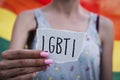 Woman showing a note with the text LGBTI