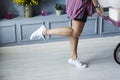 A woman showing off her legs with one foot up in the air. Royalty Free Stock Photo