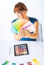 Woman showing pantone color samples