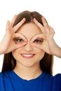 Woman showing perfect sign on eyes.