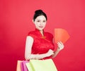 Woman showing the red envelope and shopping bags