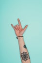 Woman showing rock sign isolated on turquoise Royalty Free Stock Photo