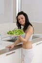Woman showing salad in kitchen Royalty Free Stock Photo