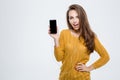 Woman showing smartphone screen