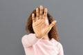 Woman showing stop hand sign over grey background Royalty Free Stock Photo