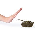 Woman showing stopping sign in front of toy tank on white background. No war concept Royalty Free Stock Photo