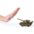 Woman showing stopping sign in front of toy tank on white background. No war concept Royalty Free Stock Photo