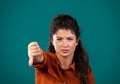 Woman showing thumb down sign gesture in studio Royalty Free Stock Photo