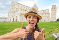 Woman showing thumbs up on piazza dei miracoli