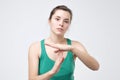 Woman showing time out gesture with hands isolated on gray wall background Royalty Free Stock Photo