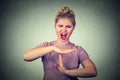 Woman showing time out hand gesture frustrated screaming to stop Royalty Free Stock Photo