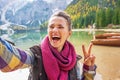 Woman showing victory gesture while making selfie Royalty Free Stock Photo