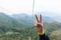 Woman showing Victory sign v sign in Cable Car Nong ping
