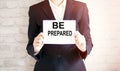 Woman showing white card with be prepared word . Business Royalty Free Stock Photo