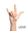 Woman showing word Love on background, closeup. American sign language