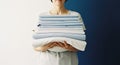 Woman Holding Stack of Clean Folded Blue and White Bed Sheets and Pillowcase Domestic Chores Laundry Day Concept Royalty Free Stock Photo