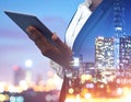 Multiple exposure of female programmer with tablet, digital binary code and night city. Royalty Free Stock Photo