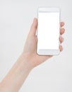 Woman shows blank display of mobile phone, hand points to device, blank screen cellular Royalty Free Stock Photo