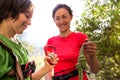 A woman shows a child how to use a carabiner for belaying