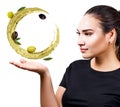 Woman shows circulate splash of olive oil with olives in hand. Royalty Free Stock Photo