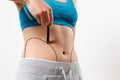 A woman shows a dotted line on her body liposuction zone Royalty Free Stock Photo