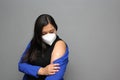 Latino adult woman shows her arm that just received the Covid-19 vaccine in the new normal