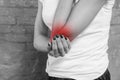 Woman shows that her elbow hurts, black and withe Royalty Free Stock Photo