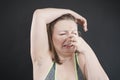 Unhappy woman shows her unshaved armpit. plus size middle age woman is not happy with hair in her armpits. Caucasian girl is Royalty Free Stock Photo